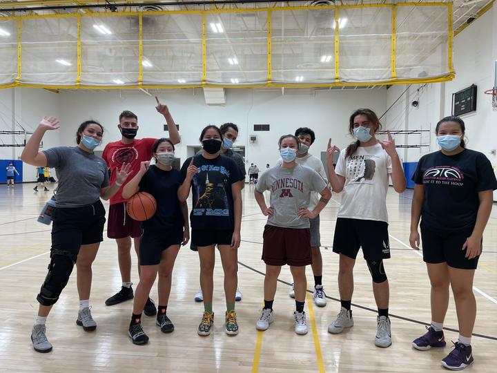 Students on the American Indian Intramural Basketball Team pose on the court after a scrimmage game